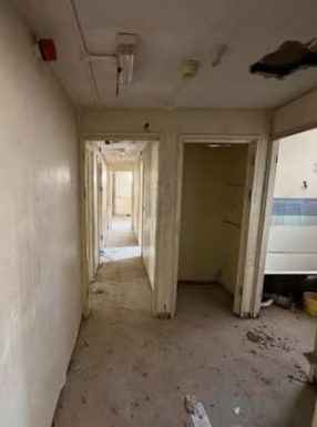 Before: corridor with doors and fittings still in place